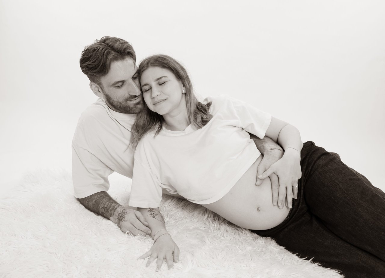 Babybauch-Shooting: S/w Paar liegend – Photography Ruel, Ebreichsdorf